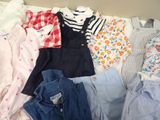 a lot of baby clothes that are laying out on the bed