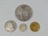 three different coins sitting on top of a table next to each other