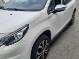 the white car is parked in the parking lot next to other cars