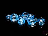 some very pretty blue glass beads on a black surface