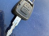 a car key attached to the hood of a car