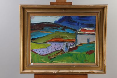 un tableau posé sur un chevalet représentant un paysage