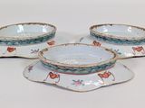 four pieces of porcelain dishes on a white surface