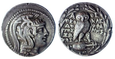 a silver coin with an image of a woman and a bird on it