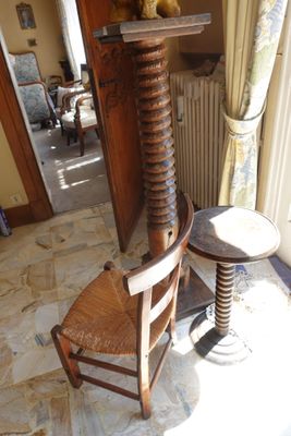a teddy bear sitting on top of a chair next to a table