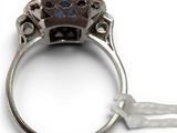 an antique silver ring with a blue stone in the center