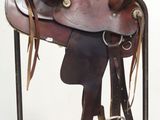 a saddle on a stand with a rope around it