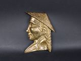 brass bust of a man with a feathered hat on his head