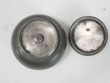 two silver pots sitting on a white surface