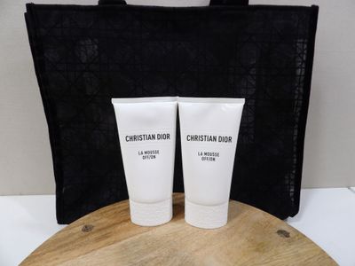 two tubes of lotion sitting on a wooden tray