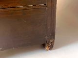 a wooden cabinet with a drawer on the bottom