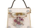 a close up of a white purse with flowers on it