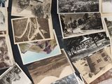 several old black and white photos of people and buildings on a table
