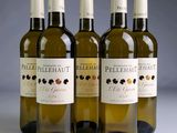 three bottles of white wine sitting next to each other on a table