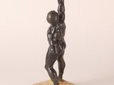 an image of a statue of a man lifting a barbell