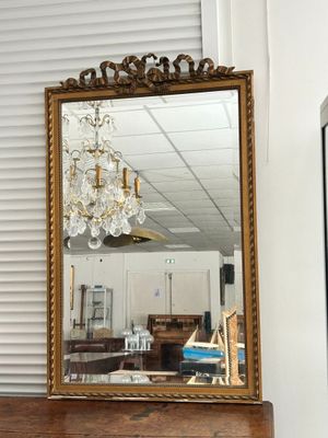a mirror that is sitting on a dresser in a room