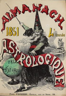 un vieux livre sur lequel figure l'image d'une sorcière tenant une pancarte
