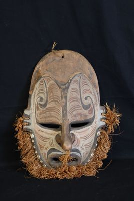 an image of a wooden mask on a black background