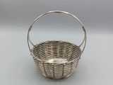 a silver plated basket with a handle and handle