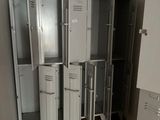 many lockers in a room with a brown tile floor