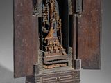 an image of a small wooden shrine with a statue in it
