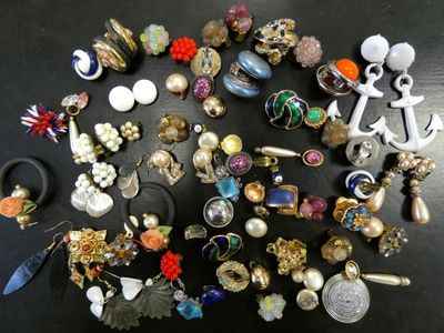 many different types of jewelry on a black table