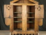 a wooden cabinet with two doors open on the floor