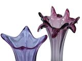 two glass vases that are sitting next to each other