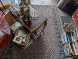 a room filled with lots of furniture and a rug