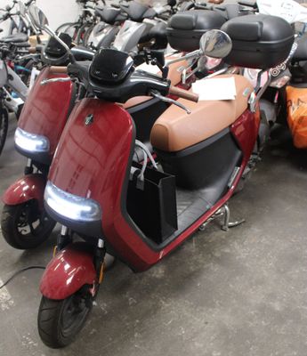 many scooters that are parked in a garage