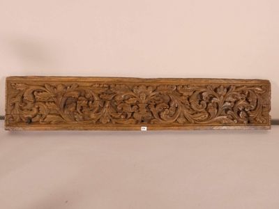 an old carved wooden door handle with a floral design
