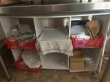 a table with a bunch of items on it in the kitchen