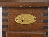 a clock with a brass plate on top of it