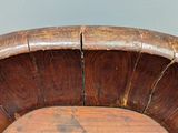 a wooden chair that has a wooden seat on it