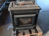 a stove that is sitting on a pallet in a garage