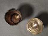 two cups that are sitting on a table