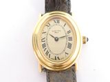a gold wrist watch with roman numerals on it