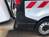 a white van with a red and white stripe on the side