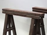 two wooden benches that are sitting on a white surface