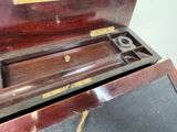 a wooden box with a pair of scissors inside of it