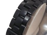 a close up of a wrist watch on a white surface