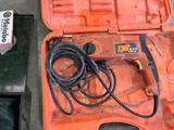 a tool in a case that is sitting on the ground