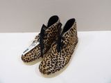 leopard print shoes on a white surface with a white background