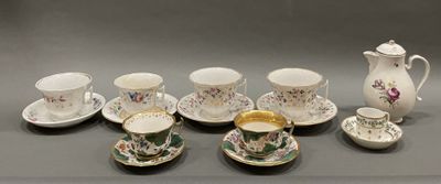 several cups and saucers are lined up on a table