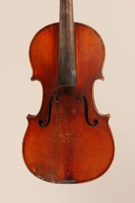 an old violin with a bow hanging from it ' s back