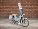 a blue motor bike with a plastic cover on the back