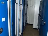 many blue lockers lined up in the hallway of a building