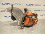 a close up of a chainsaw on a table in front of a wall