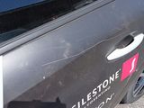 a close up of a car door with a sticker on it
