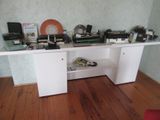 a desk with a lot of electronics on top of it